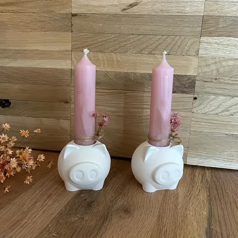 White 3D pig candle holders with pink candles