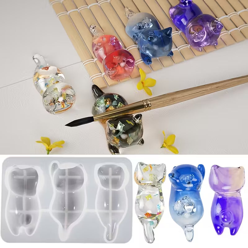 Resin cat figures beside the 3pc 3D lying cat silicone mould